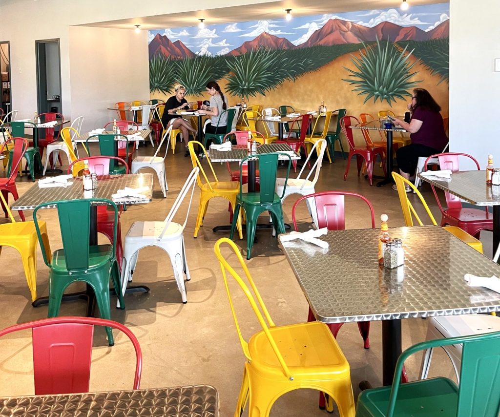 A family enjoying Mexican food in a restaurant with a family-friendly atmosphere in Metairie.