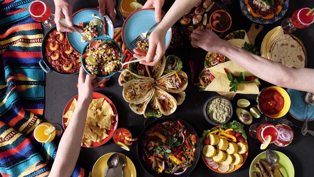 A Mexican family celebrates Cinco de Mayo with a festive feast, showcasing the rich, global flavors of Mexican cuisine.