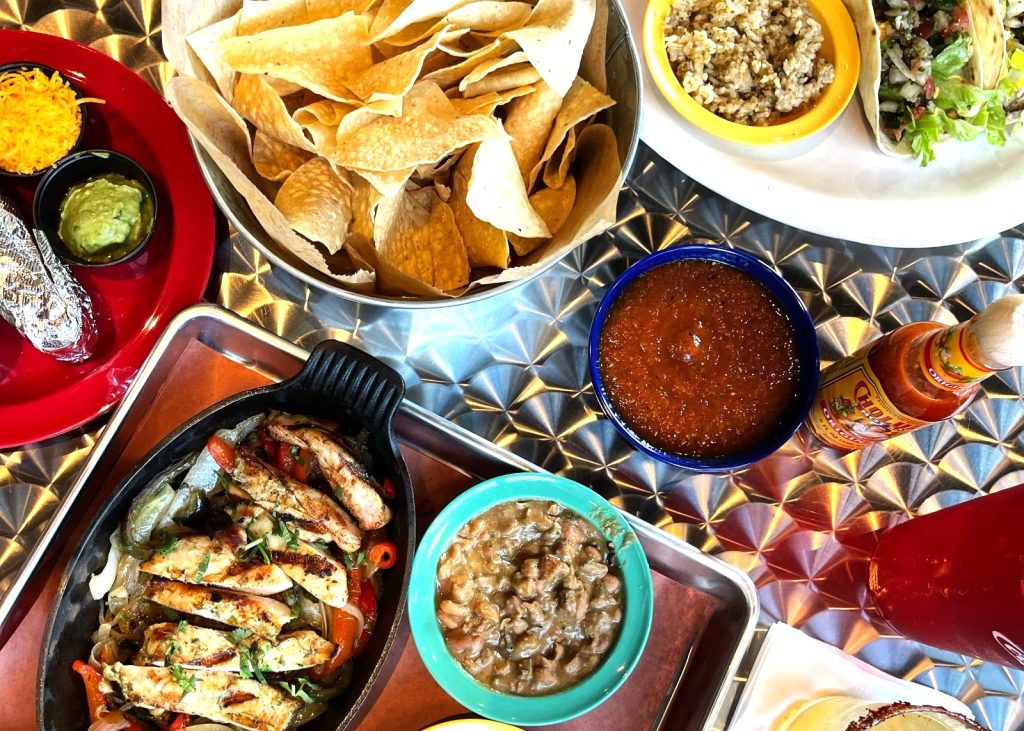 Freshly prepared guacamole served alongside crispy nachos, garnished with vibrant, fresh toppings. Mexican food in Metairie