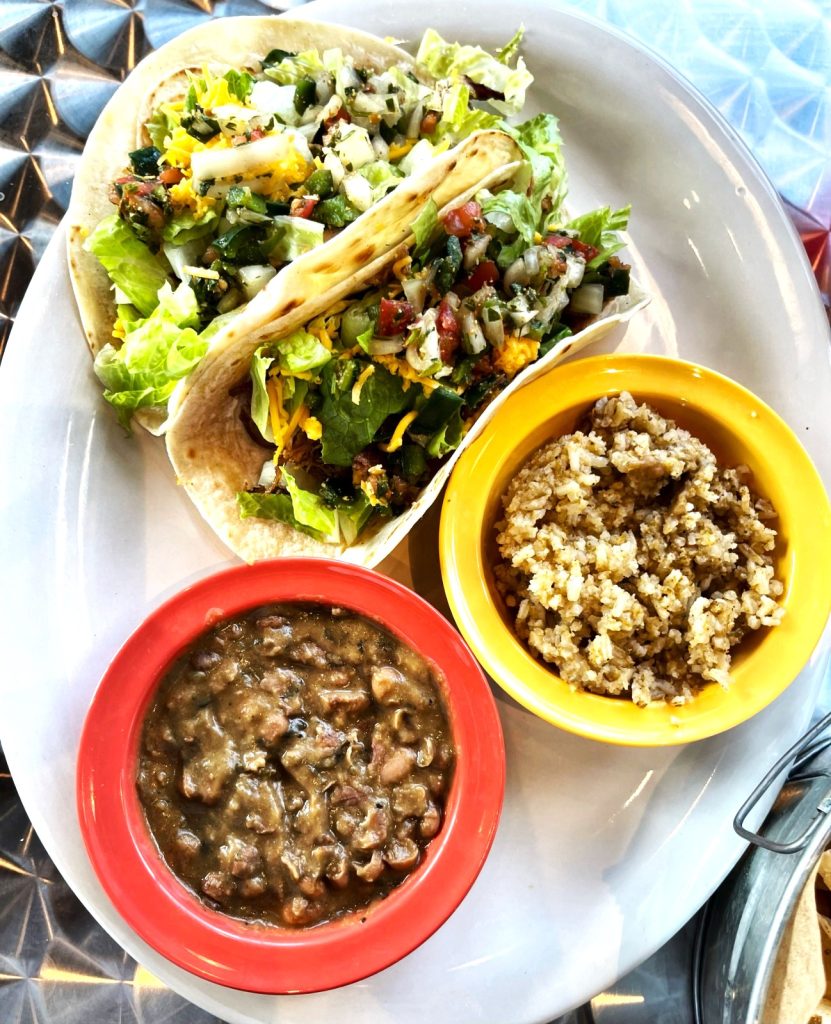 A patron enjoying Tacos al Pastor at Las Cruces Tex Mex, showcasing authentic Mexican cuisine in Metairie, Louisiana.