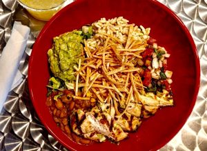A dinner plate from Las Cruces Tex Mex, a Mexican restaurant in Metairie featuring grilled chicken breast topped with crispy tortilla strips.